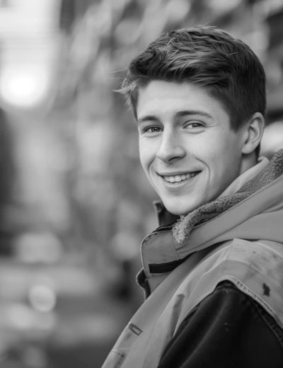 Portrait of happy young man warehouse worker wearing safety jacket looking at camera, HD, photorealistic, high quality 32 k, candid moments captured, award winning, comission for, photo taken with Canon R6 Mark II, HDR, telephoto lens --ar 3:2 --v 6 Job ID: 300388be-f587-44e1-ae68-bece5cfb0617