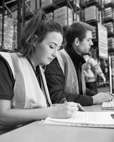 Staff managing warehouse logistics in an on-site office