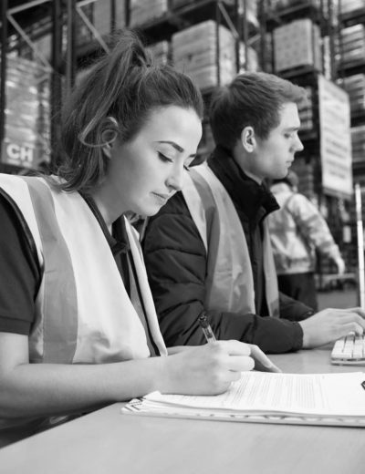 Staff managing warehouse logistics in an on-site office